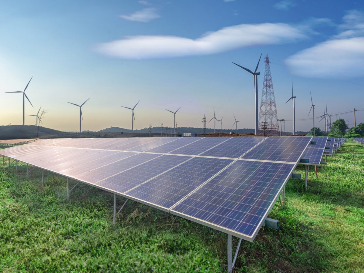renewable-energy-solar-panels-wind-turbines-green-grass-blue-sky